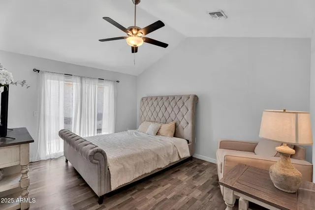 a bedroom with a bed and a lamp