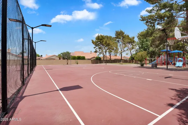 a view of a playground with basketball court