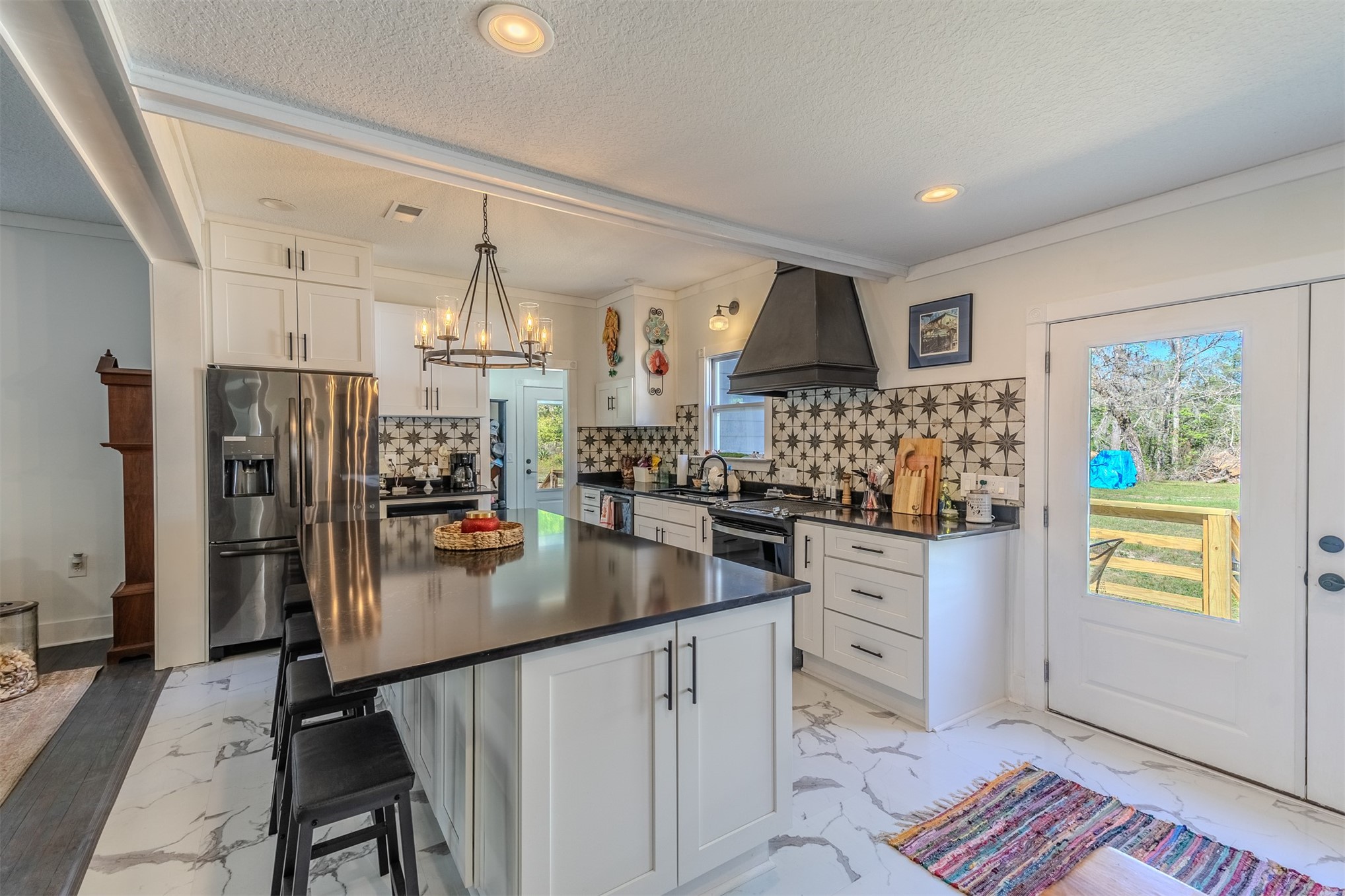 28180 Lake Hampton Road Hilliard, FL 32046 - Photo 11 of 34 a kitchen with stainless steel appliances granite countertop a refrigerator sink and stove