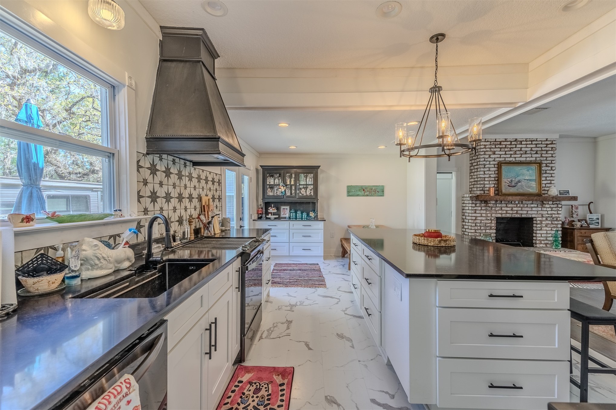 28180 Lake Hampton Road Hilliard, FL 32046 - Photo 12 of 34 a kitchen with a sink stove and cabinets