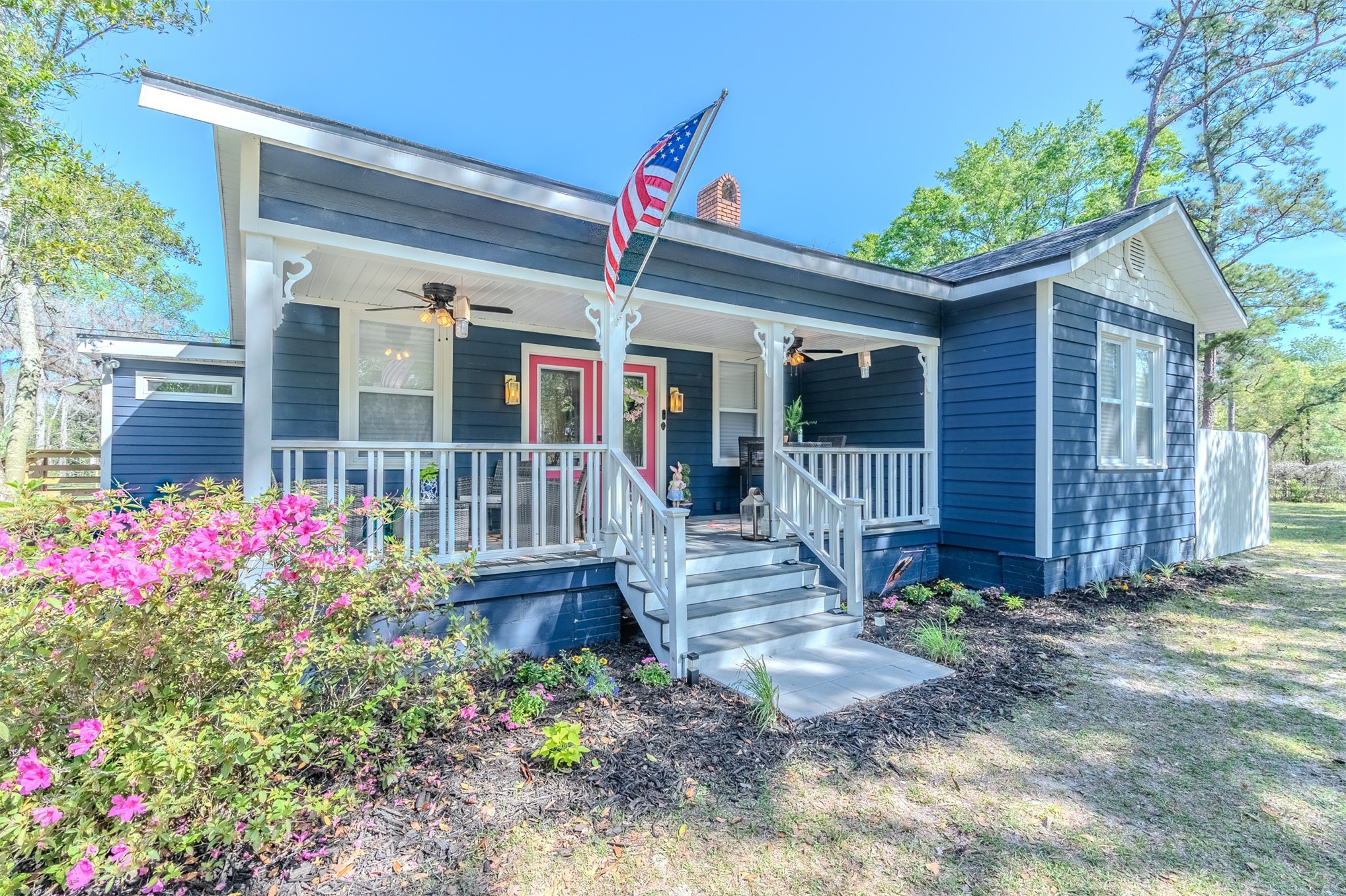 28180 Lake Hampton Road Hilliard, FL 32046 - Photo 2 of 34 a view of a house with large windows and flower plants