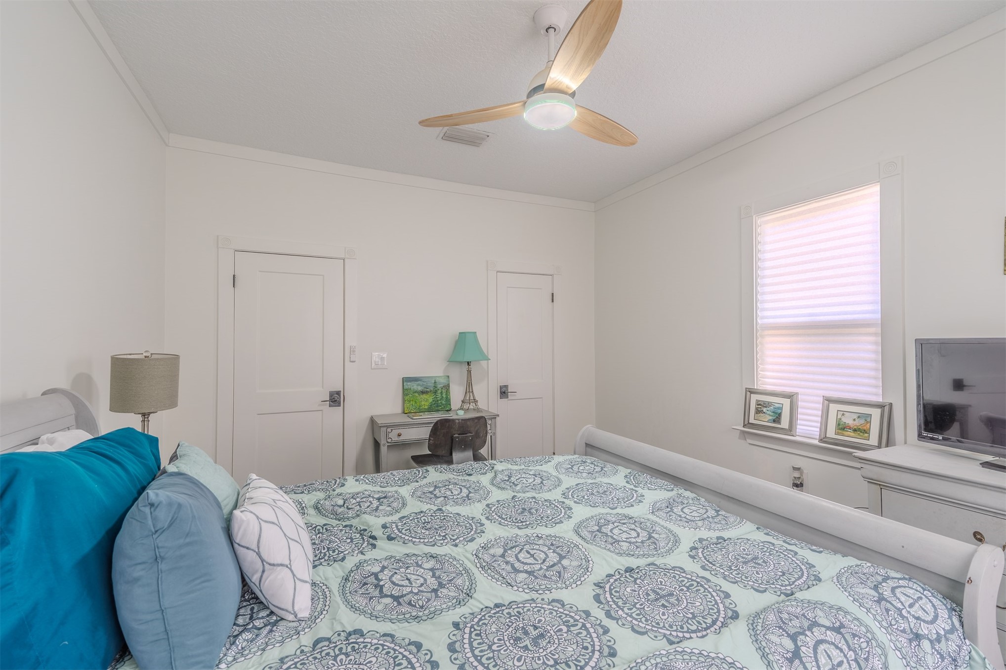 28180 Lake Hampton Road Hilliard, FL 32046 - Photo 28 of 34 a bed room with a bed window and a chandelier
