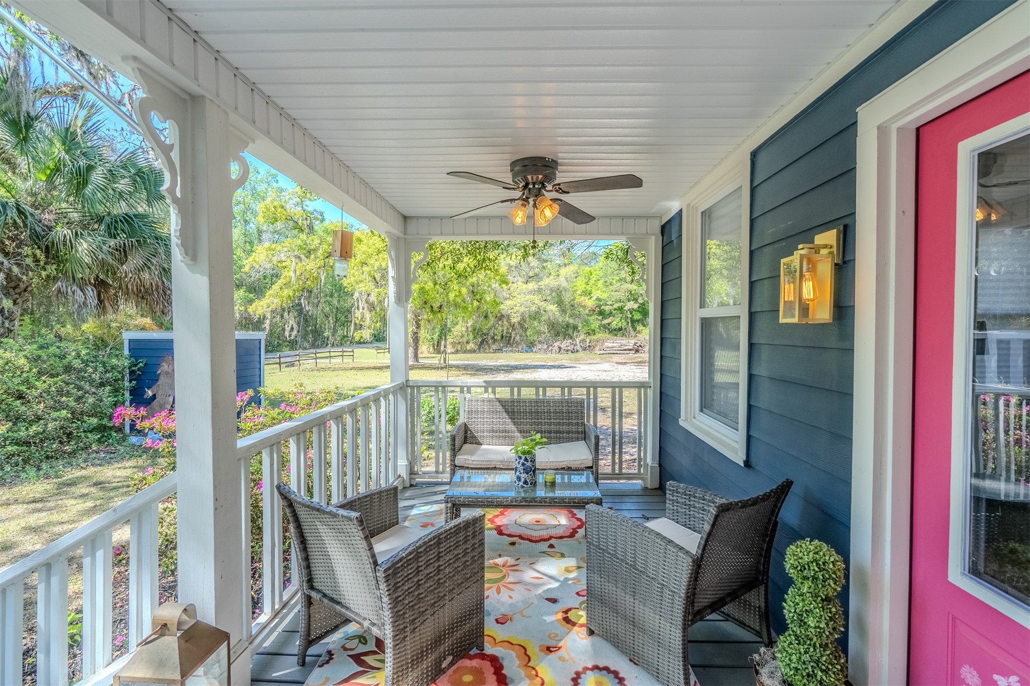 28180 Lake Hampton Road Hilliard, FL 32046 - Photo 6 of 34 a view of a patio with table and chairs potted plants with wooden floor