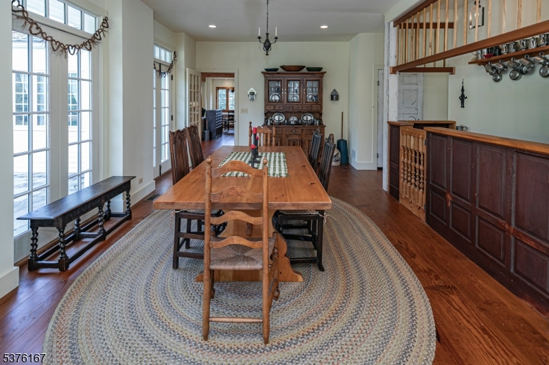 348 Rosemont Ringoes Road Stockton, NJ 08559 - Photo 15 of 42 a dining room with furniture a rug and wooden floor