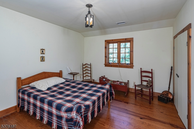 348 Rosemont Ringoes Road Stockton, NJ 08559 - Photo 31 of 42 a bedroom with a bed and wooden floor
