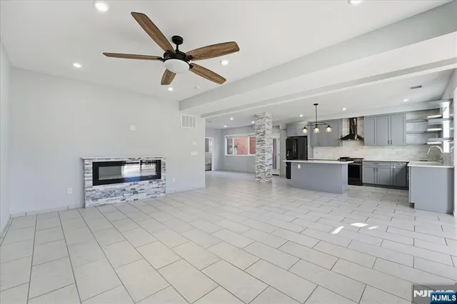 a view of kitchen with microwave and cabinets
