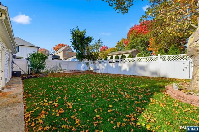 a view of house with outdoor space and garden