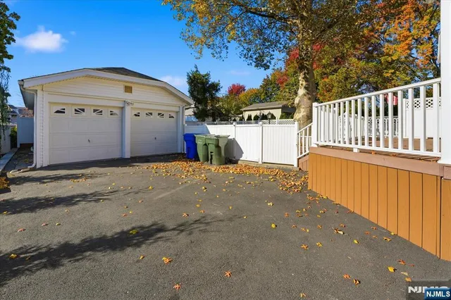 a view of a house with wooden fence