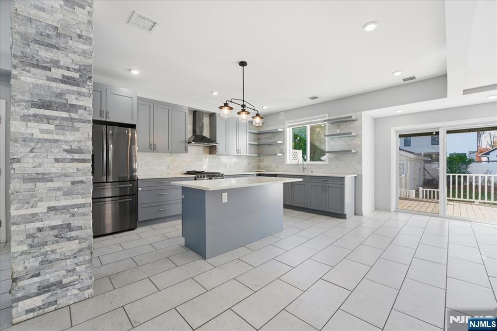 85 Beckwith Place, Unit 1 Rutherford, NJ 07070 - Photo 4 of 20 a large kitchen with granite countertop a stove a sink dishwasher and a refrigerator