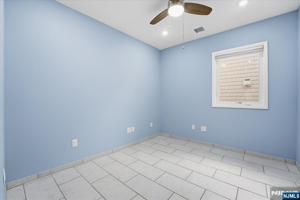 85 Beckwith Place, Unit 1 Rutherford, NJ 07070 - Photo 7 of 20 a view of an empty room with a window