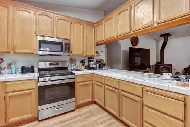 a kitchen with sink refrigerator and cabinets