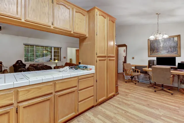 a view of a workspace with furniture and a bookshelf