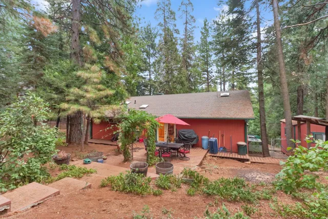 a backyard of a house with table and chairs