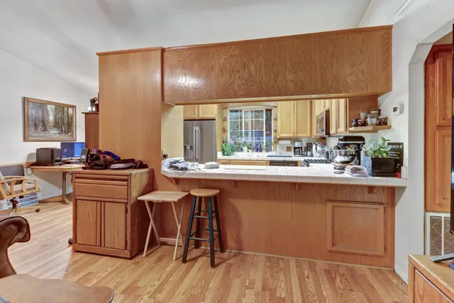a kitchen with stainless steel appliances a refrigerator sink and cabinets