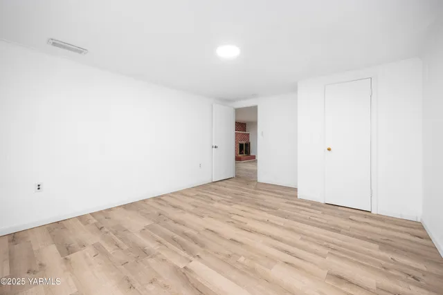 a view of a livingroom with wooden floor and closet