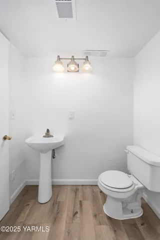 a view of kitchen with cabinets and wooden floor