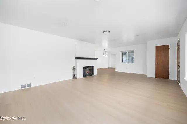a view of empty room with fireplace