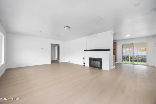 an empty room with furniture and fireplace