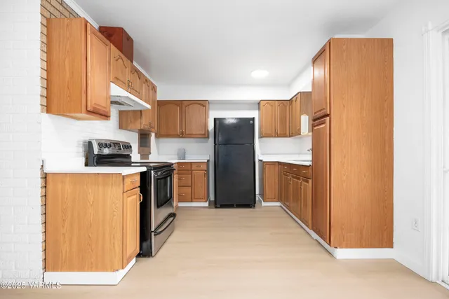 a kitchen with stainless steel appliances granite countertop a refrigerator and a stove