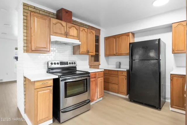 a kitchen with a stove refrigerator and a sink