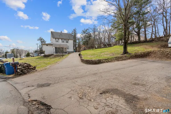 a view of a house with a yard and garage