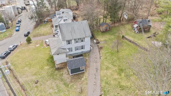 an aerial view of residential house with pool and yard