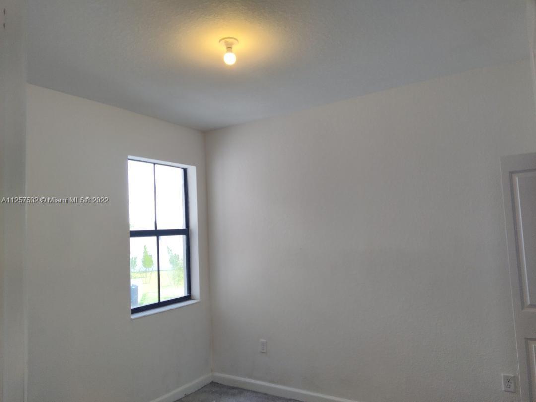 18232 Southwest 148th Road Miami, FL 33187 - Photo 11 of 32 an empty room with a window