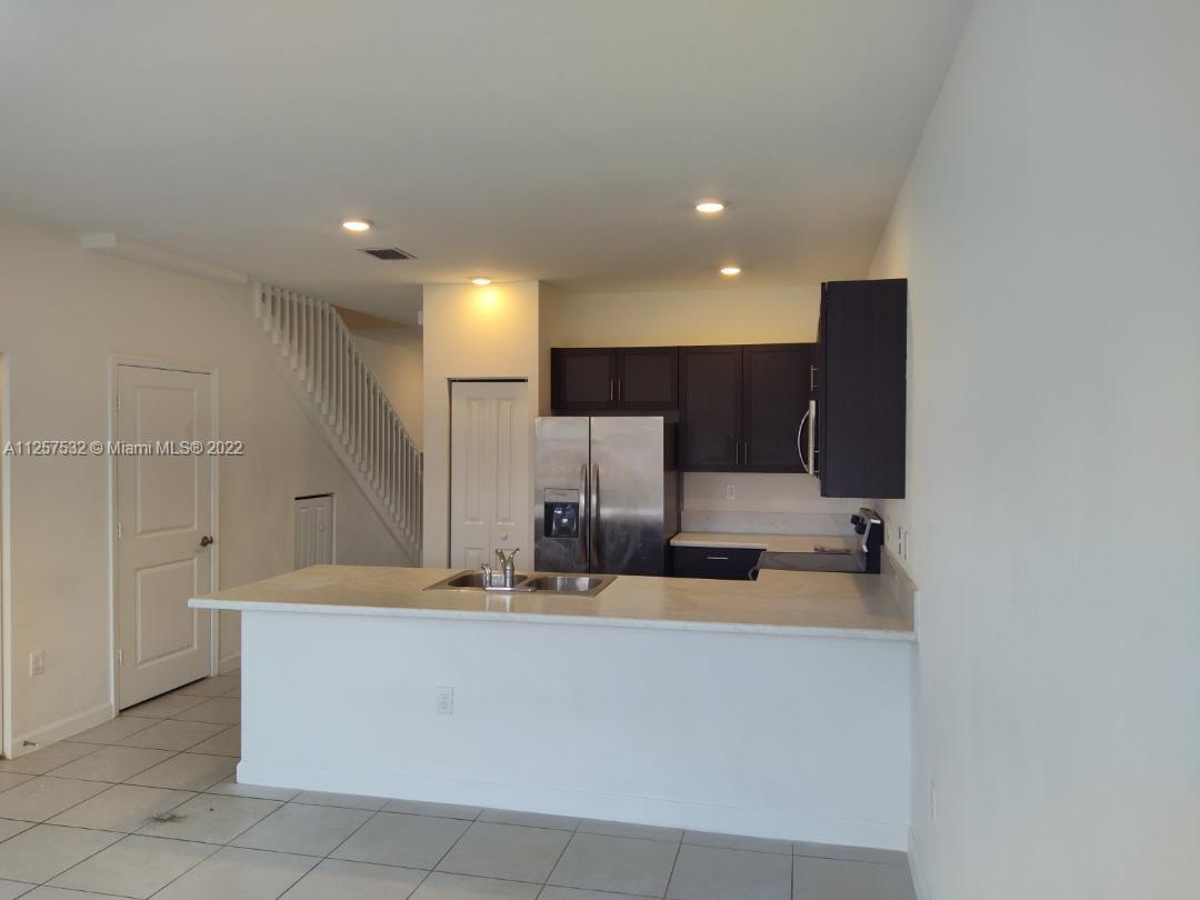 18232 Southwest 148th Road Miami, FL 33187 - Photo 13 of 32 a large kitchen with a large counter top