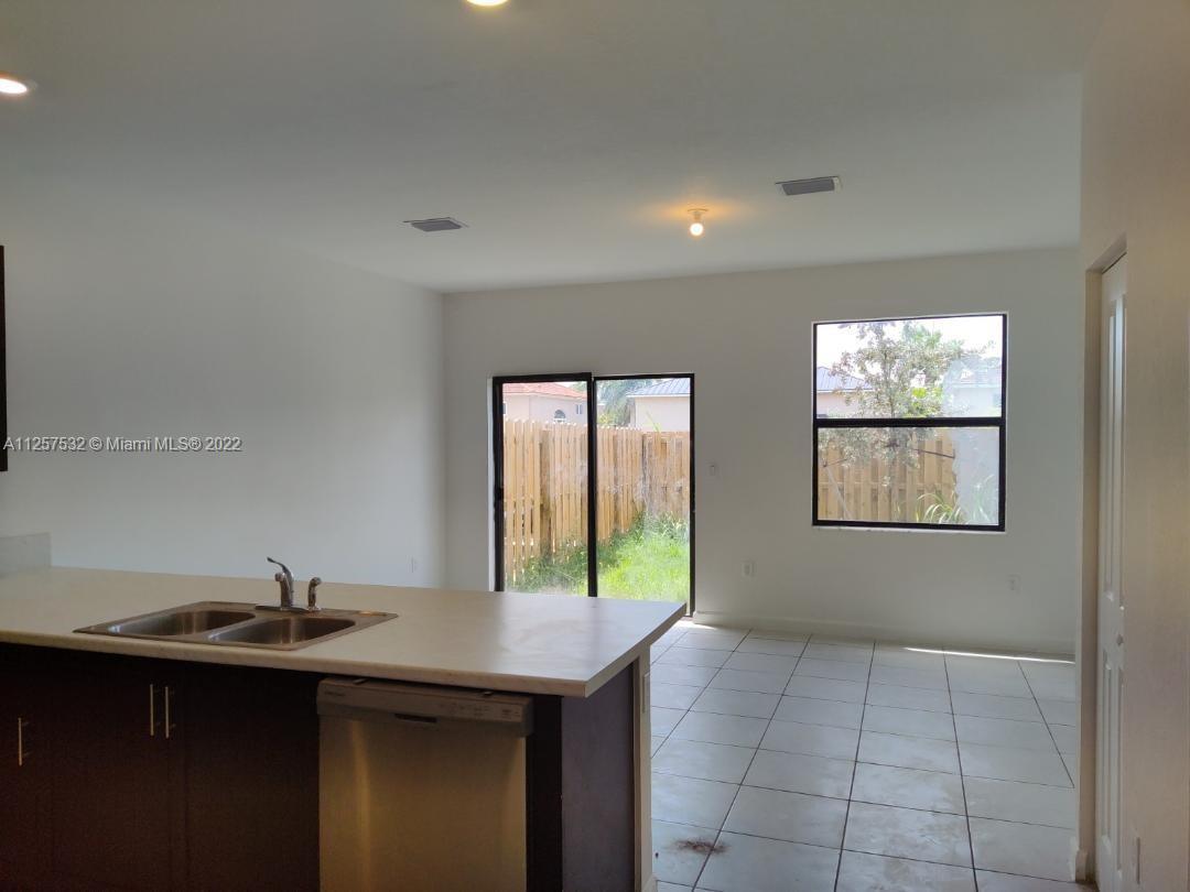 18232 Southwest 148th Road Miami, FL 33187 - Photo 14 of 32 a kitchen with a sink and large window