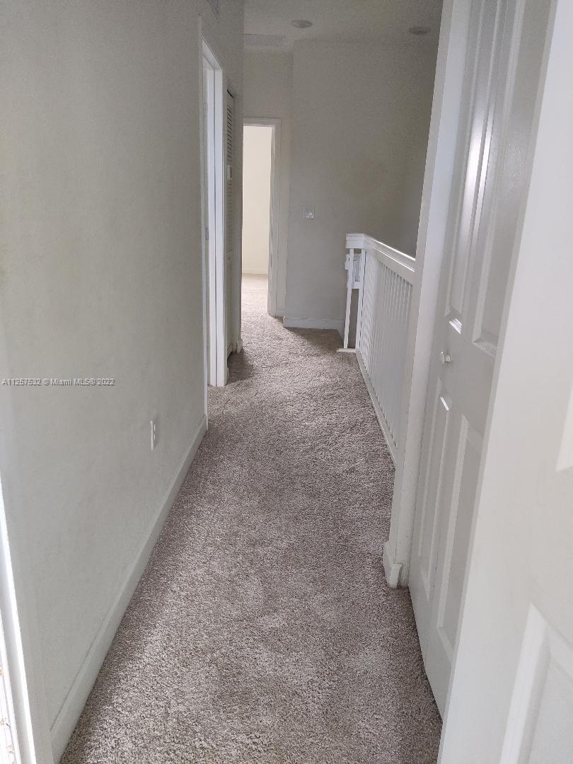 18232 Southwest 148th Road Miami, FL 33187 - Photo 17 of 32 an entryway of a house with a hallway