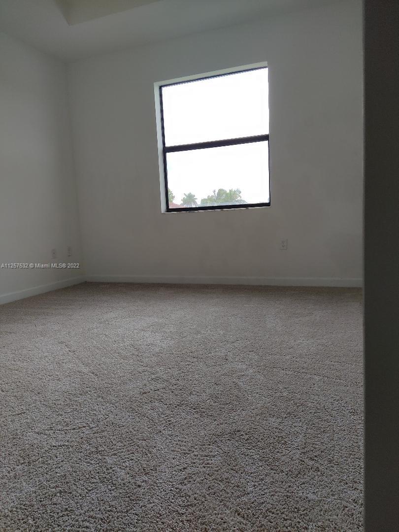 18232 Southwest 148th Road Miami, FL 33187 - Photo 18 of 32 an empty room with a window