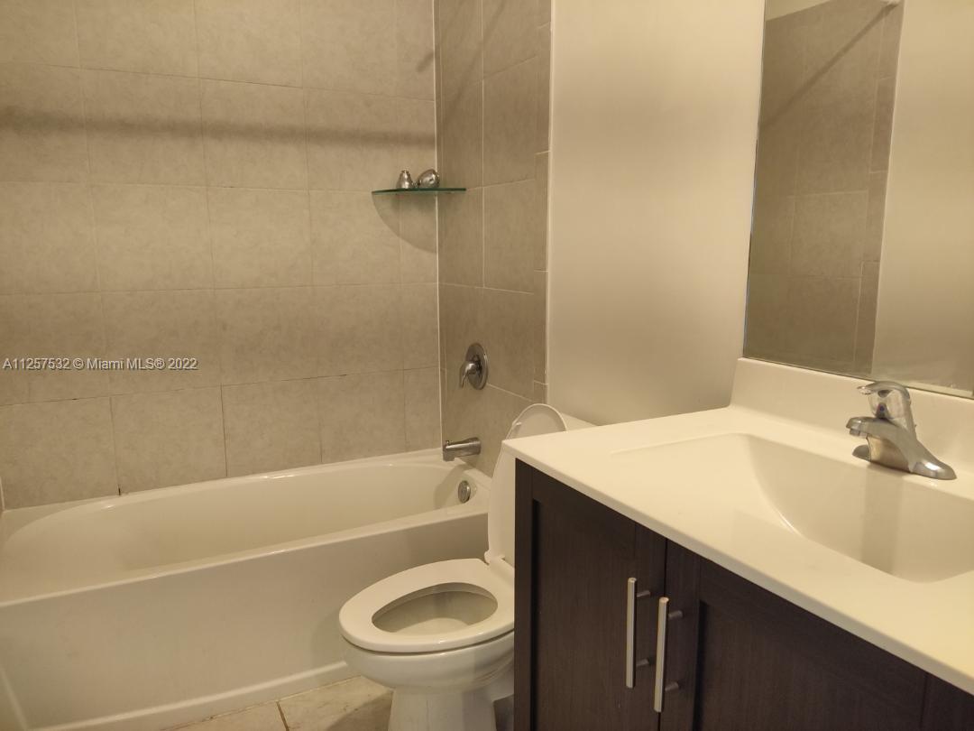 18232 Southwest 148th Road Miami, FL 33187 - Photo 20 of 32 a bathroom with a sink a toilet and shower