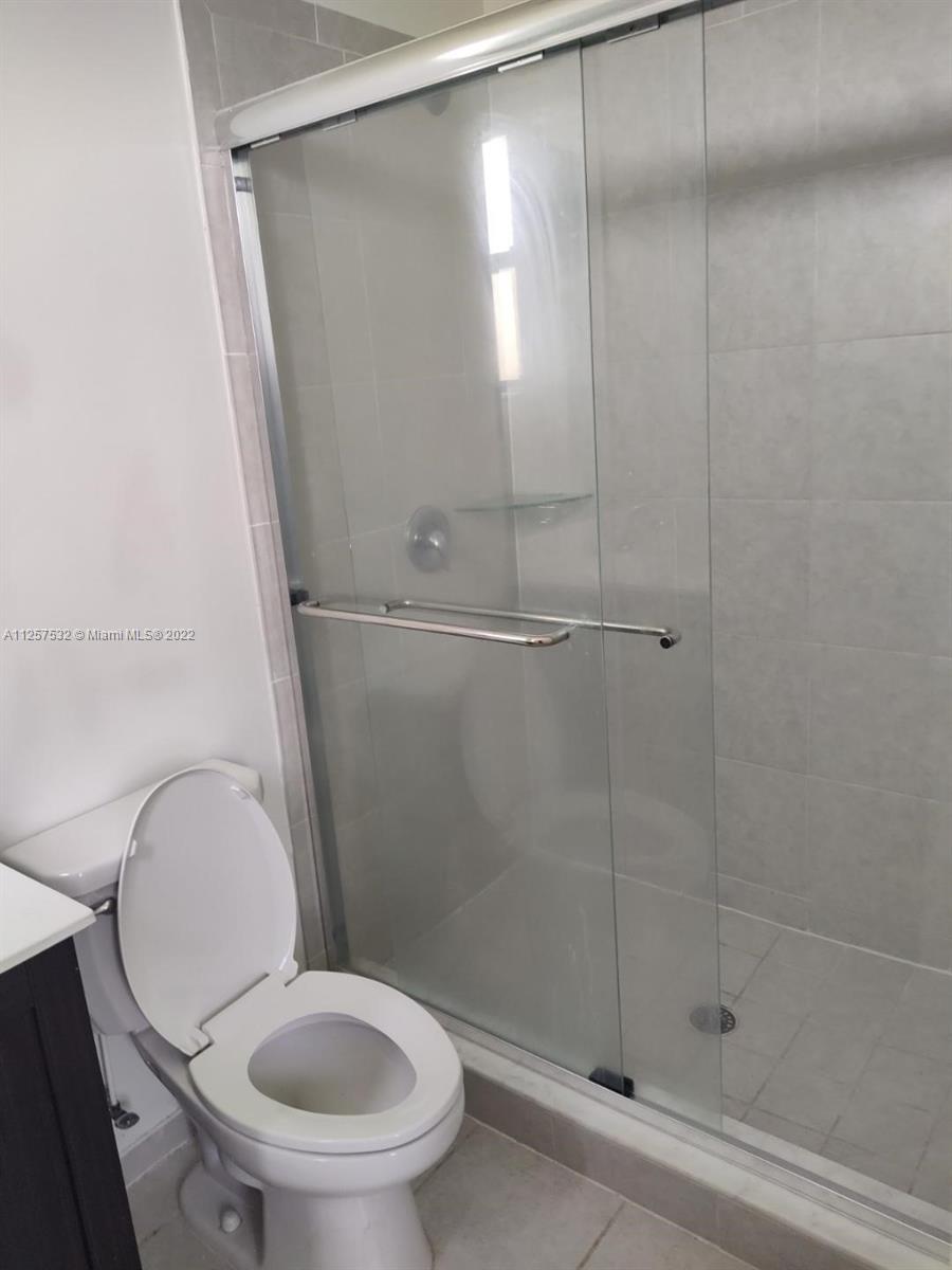 18232 Southwest 148th Road Miami, FL 33187 - Photo 21 of 32 a bathroom with a toilet and a shower