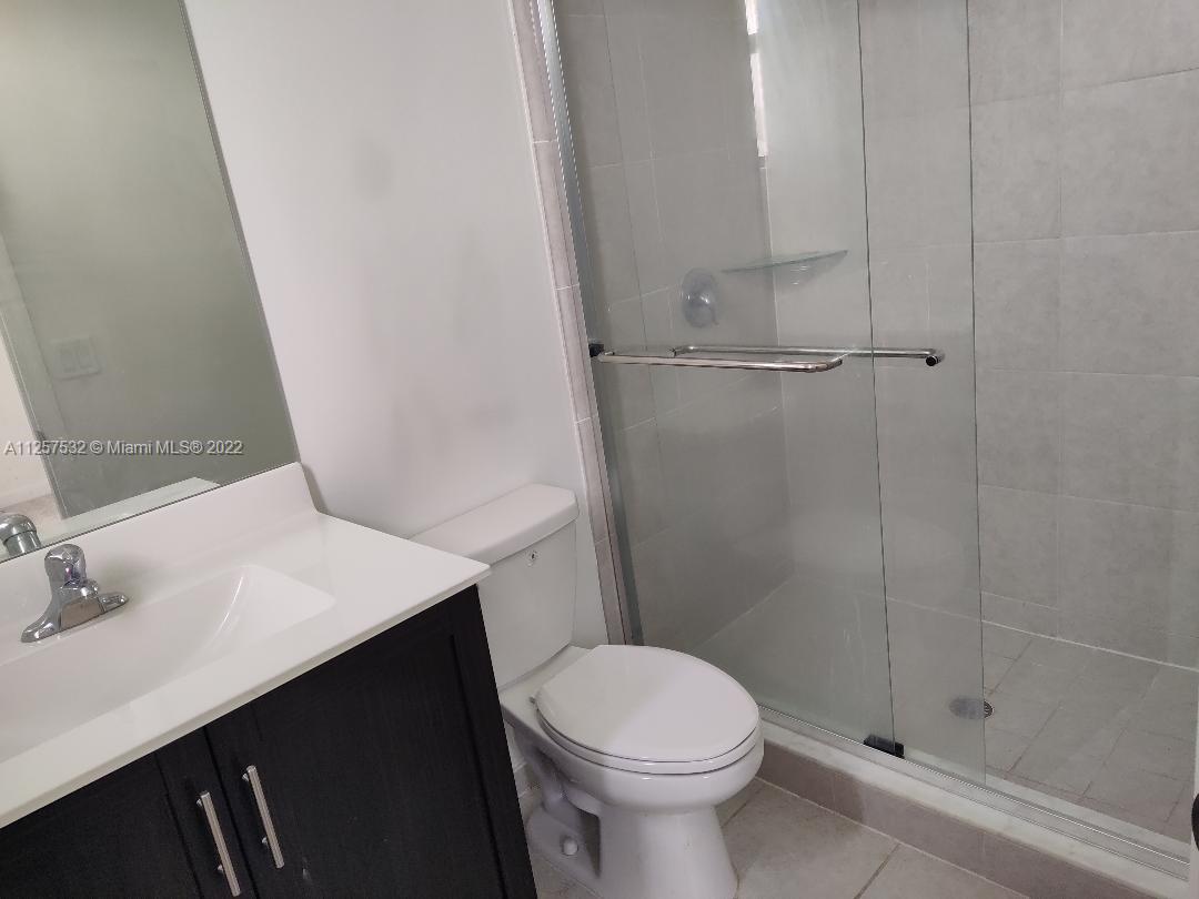 18232 Southwest 148th Road Miami, FL 33187 - Photo 24 of 32 a bathroom with a sink a toilet and shower