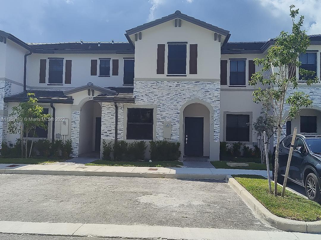 18232 Southwest 148th Road Miami, FL 33187 - Photo 25 of 32 a front view of a house with yard