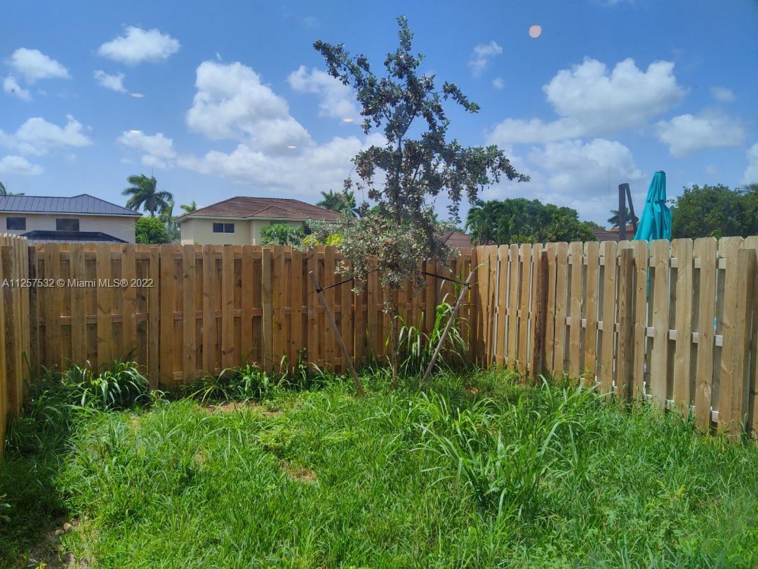 18232 Southwest 148th Road Miami, FL 33187 - Photo 26 of 32 a view of a garden with a building in the background