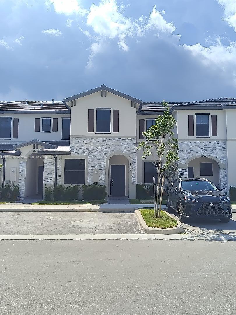 18232 Southwest 148th Road Miami, FL 33187 - Photo 28 of 32 a front view of a house with yard