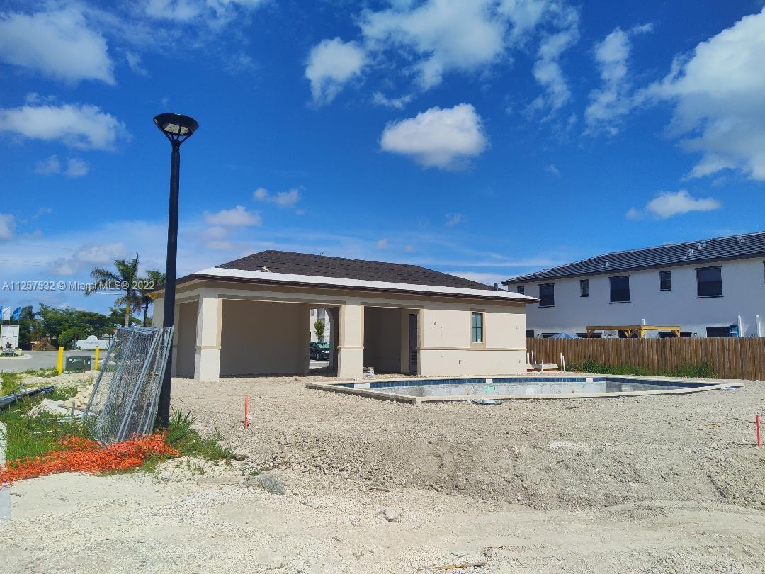 18232 Southwest 148th Road Miami, FL 33187 - Photo 29 of 32 a front view of a house with a yard