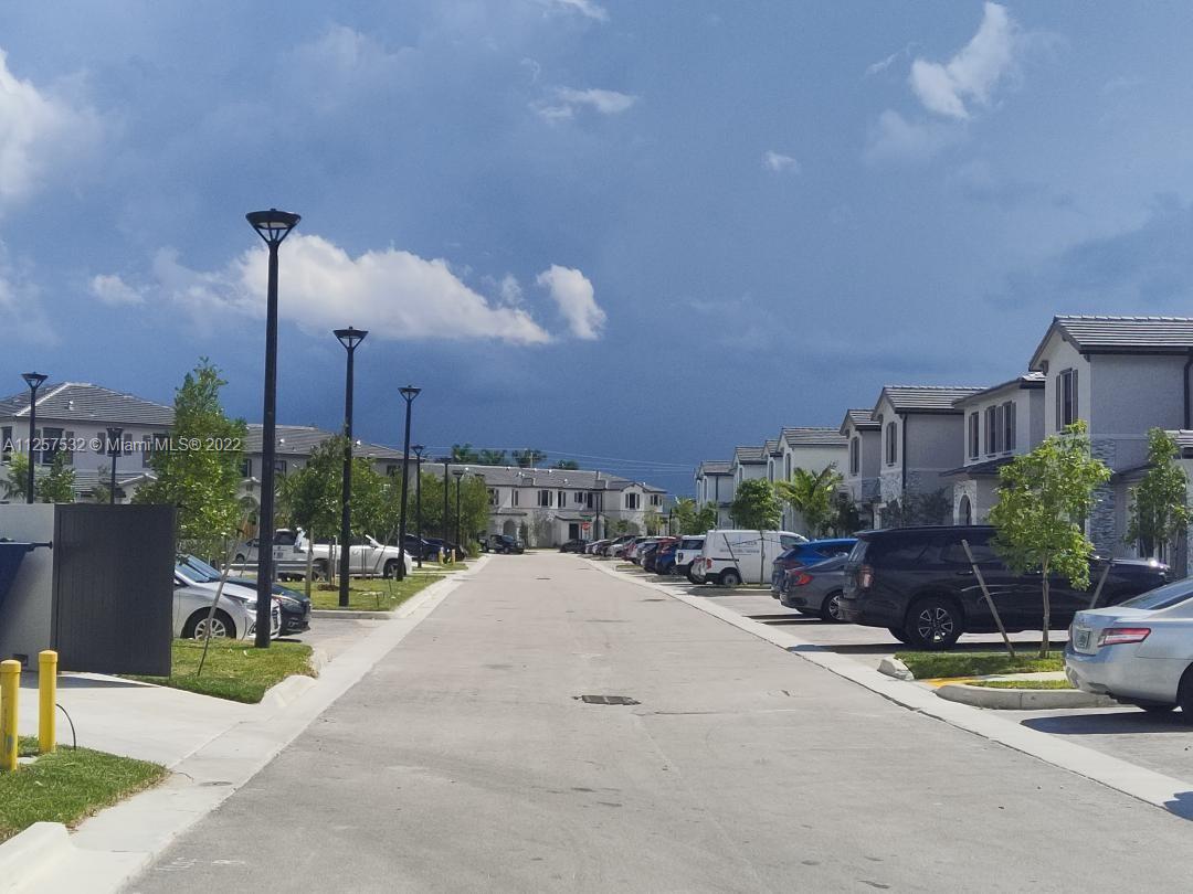18232 Southwest 148th Road Miami, FL 33187 - Photo 30 of 32 a view of a street with a bench and a table