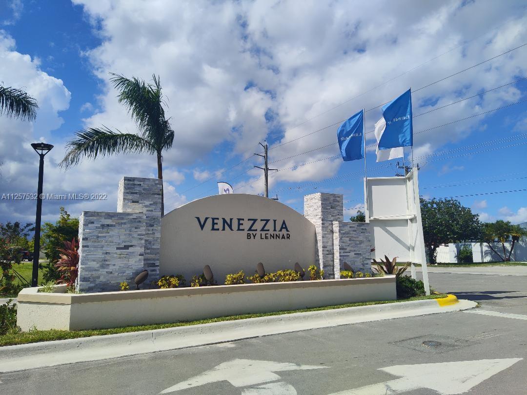 18232 Southwest 148th Road Miami, FL 33187 - Photo 3 of 32 a sign on the side of a building