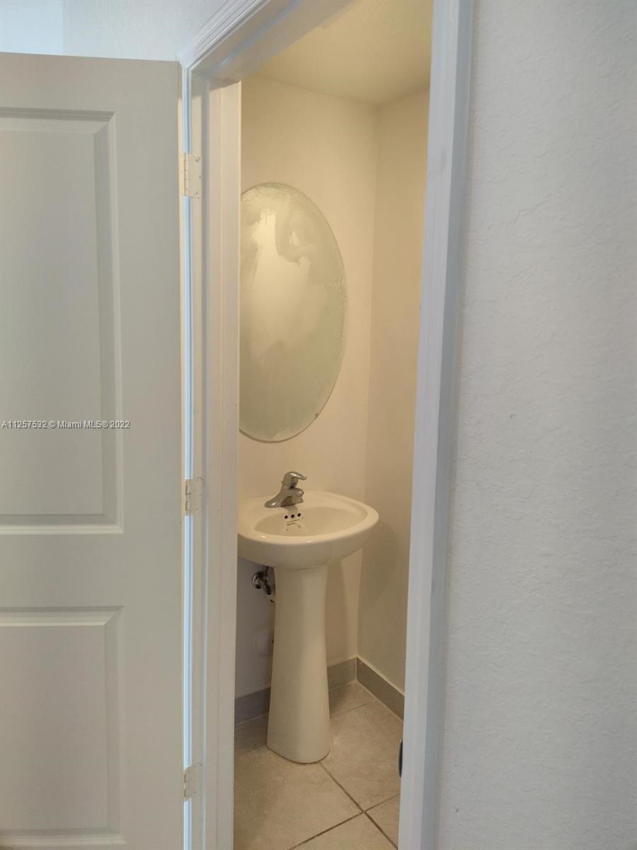 18232 Southwest 148th Road Miami, FL 33187 - Photo 10 of 32 a bathroom with a sink and mirror
