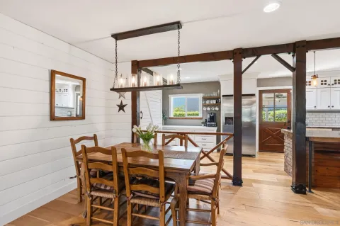 a dining room with furniture and large windows