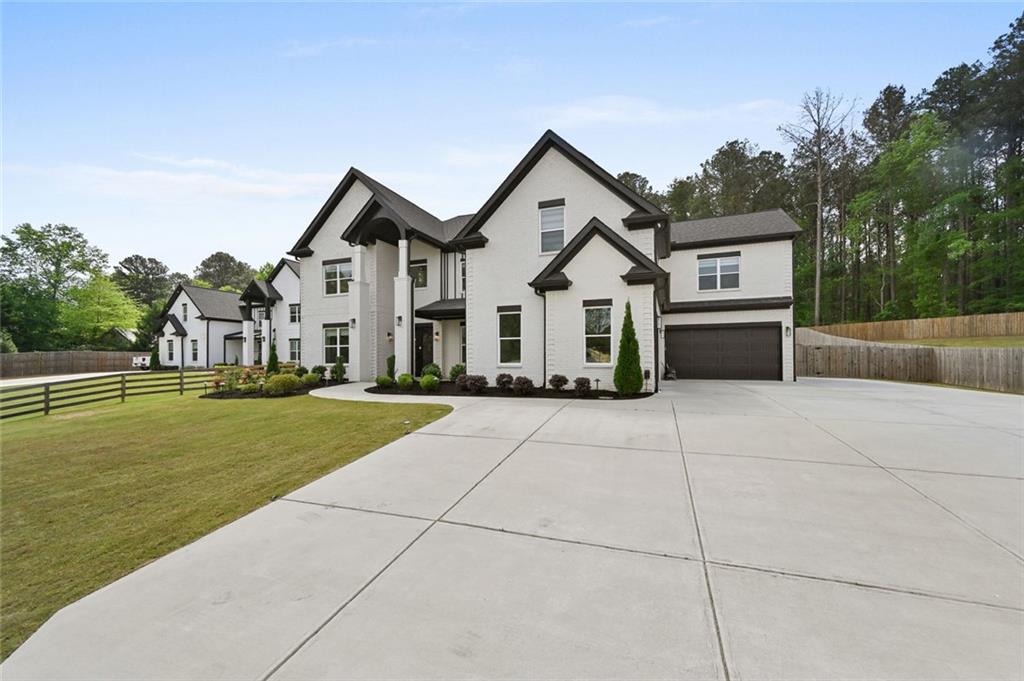 2694 Thompson Mill Road Buford, GA 30519 - Photo 4 of 70 a front view of a house with a yard