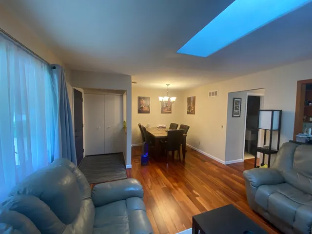 a living room with furniture and a dining table
