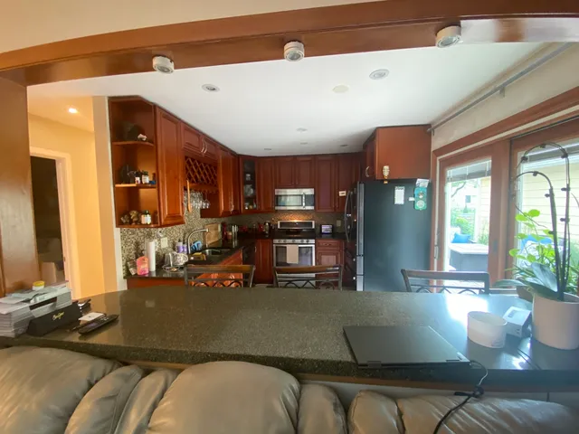a living room with furniture and kitchen view