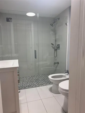 a bathroom with a toilet a sink and shower