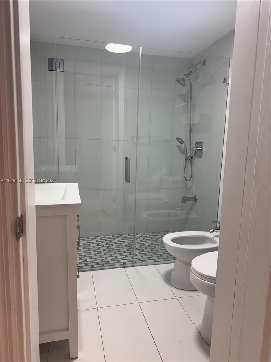 881 Hialeah Drive Hialeah, FL 33010 - Photo 15 of 36 a bathroom with a toilet a sink and shower