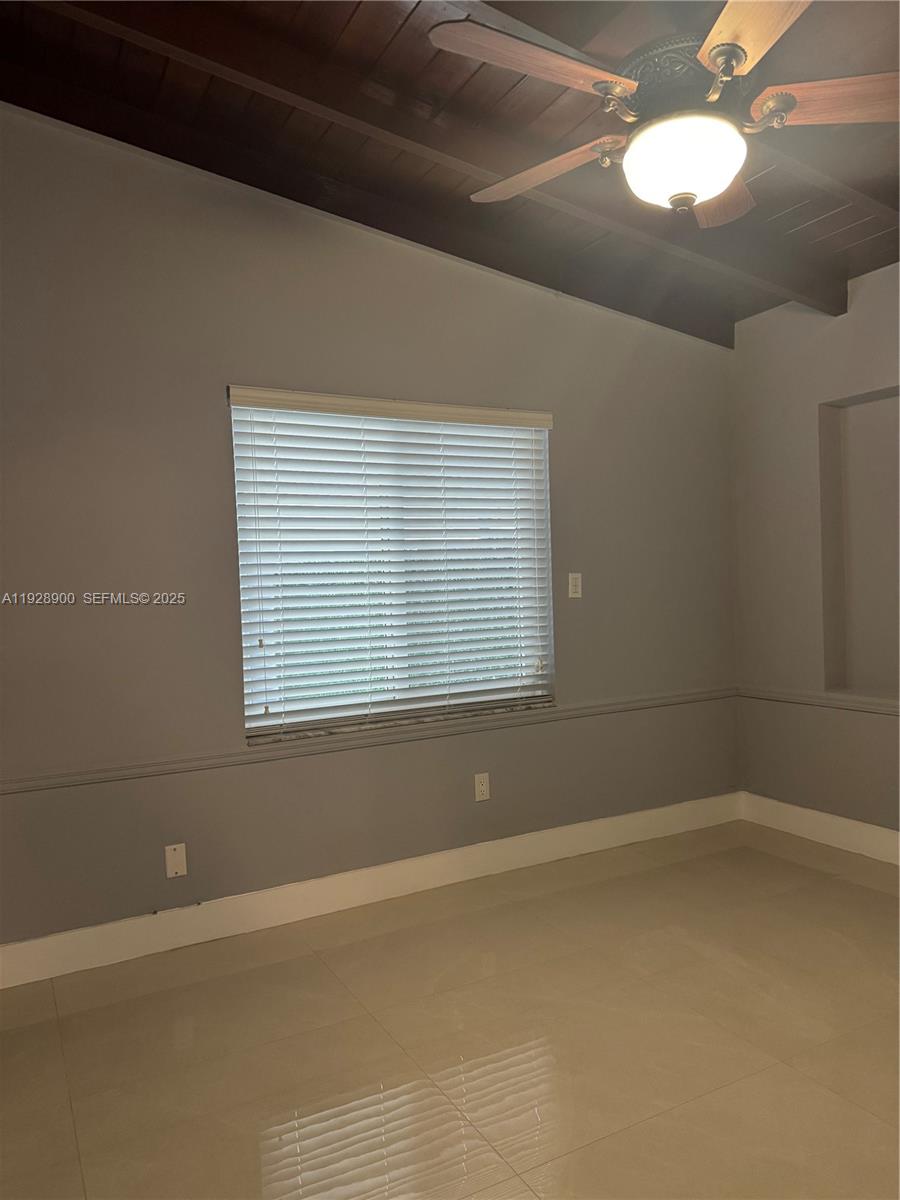 881 Hialeah Drive Hialeah, FL 33010 - Photo 20 of 36 a view of a room with blue walls and a window