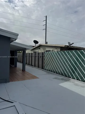a room with a wooden floor and a window