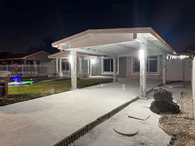 a view of a house with iron fence